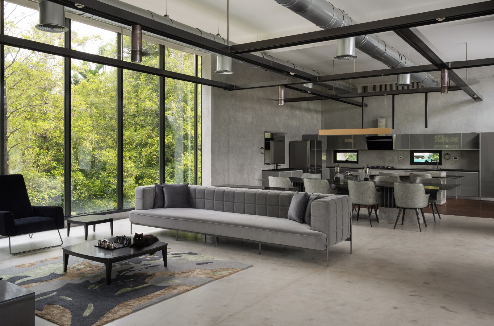 Sovnear estate living room — floor-to-ceiling glass with forest views